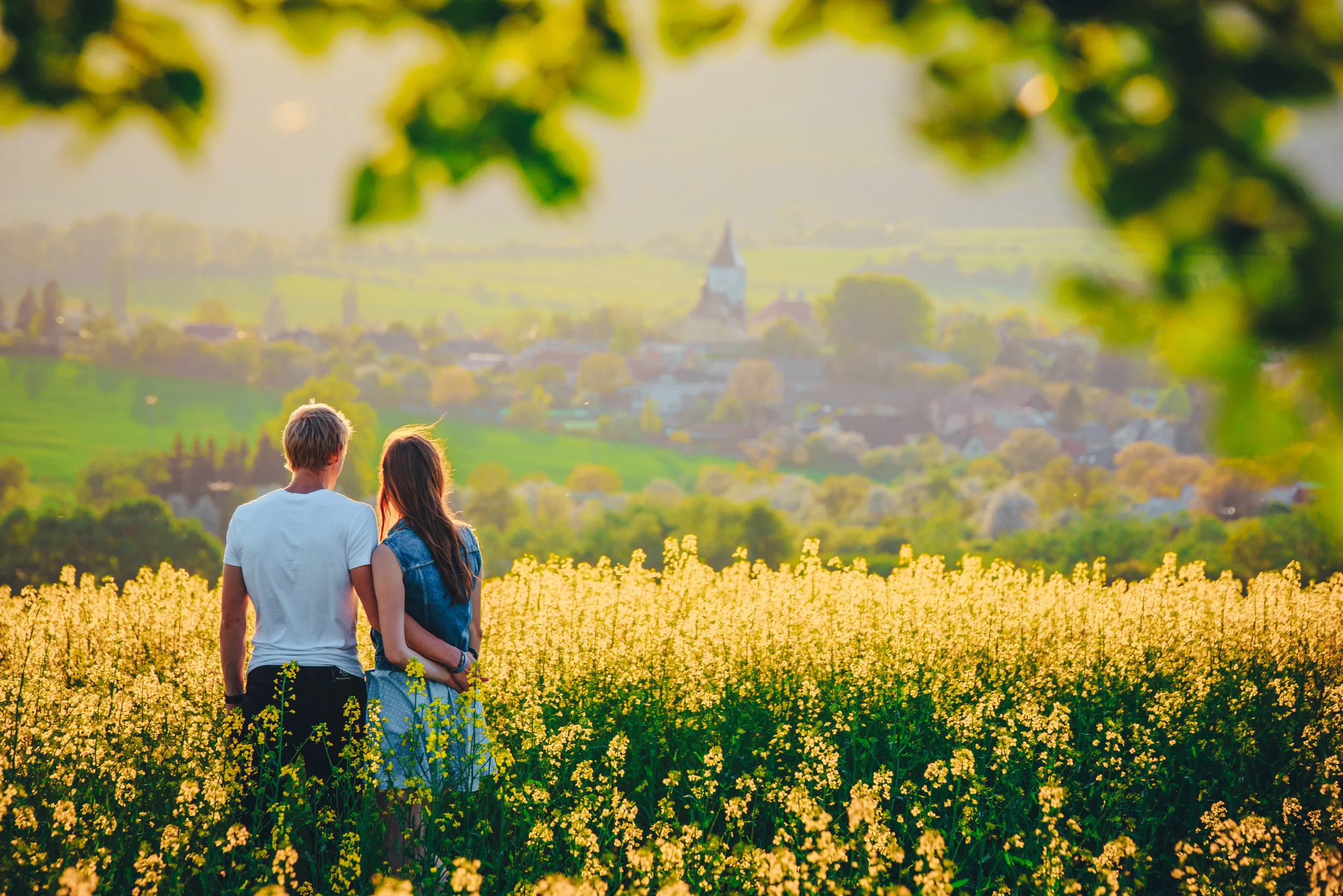 couple stands together in a field