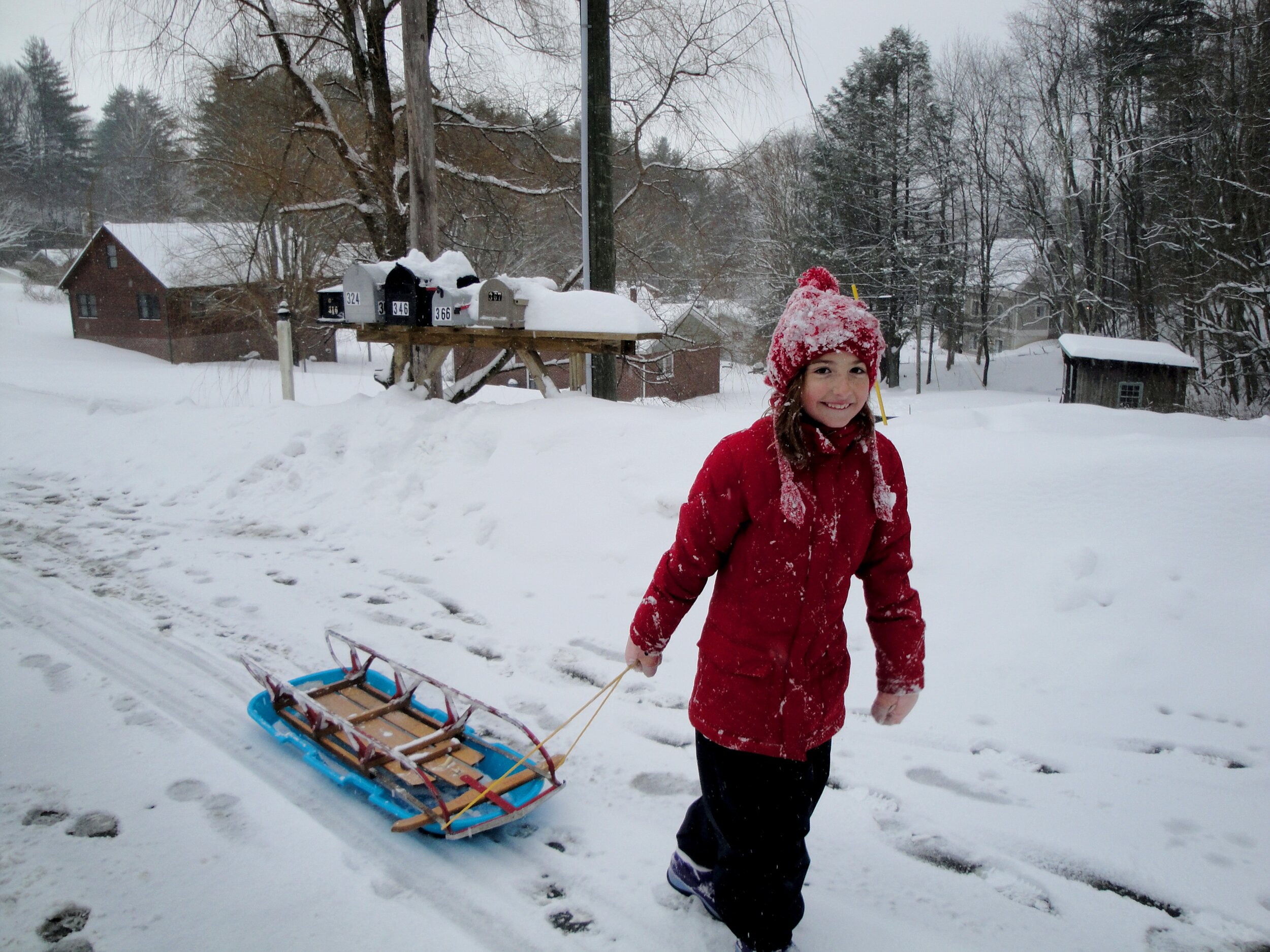 girl pulling sled