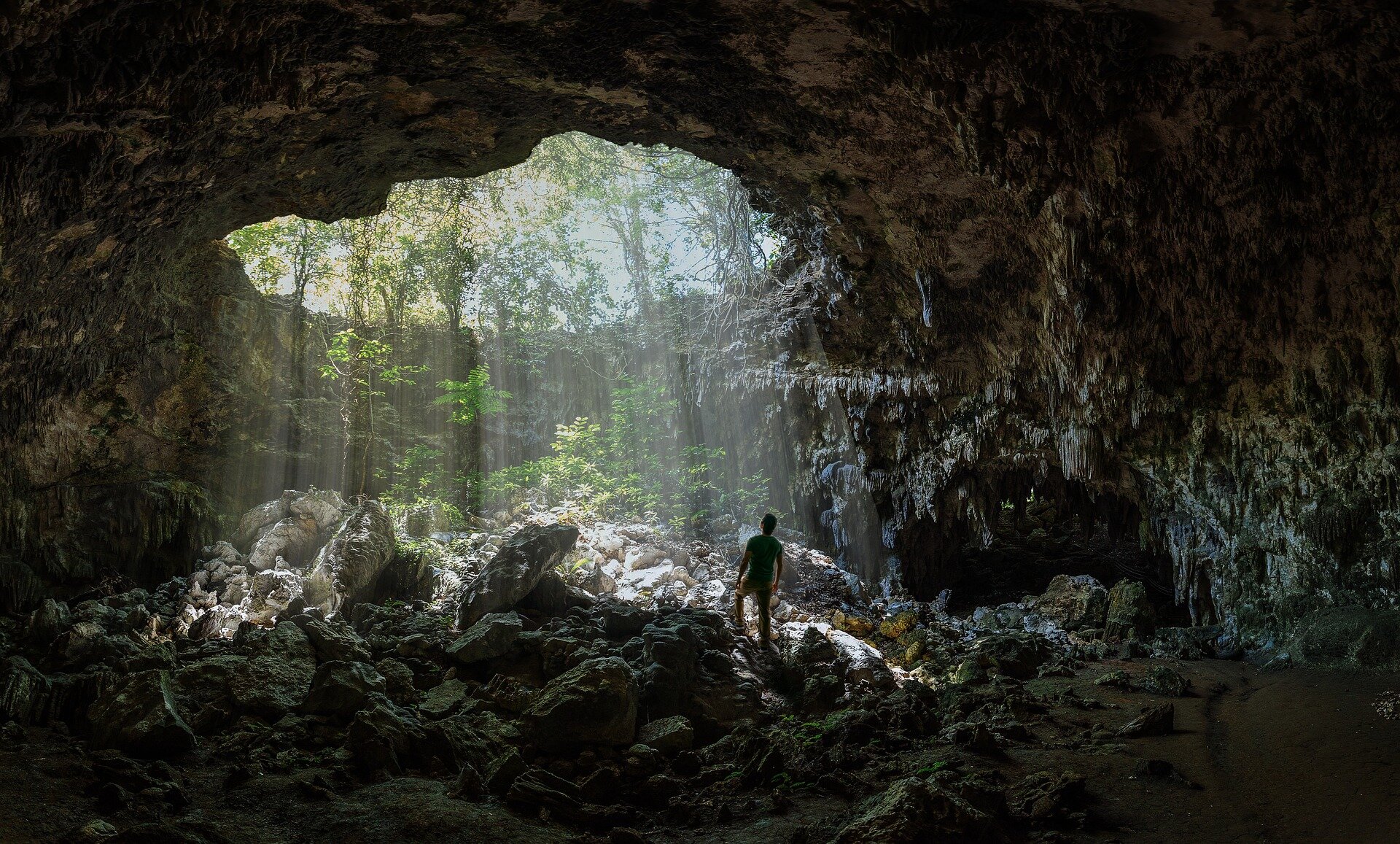 man under cave opening