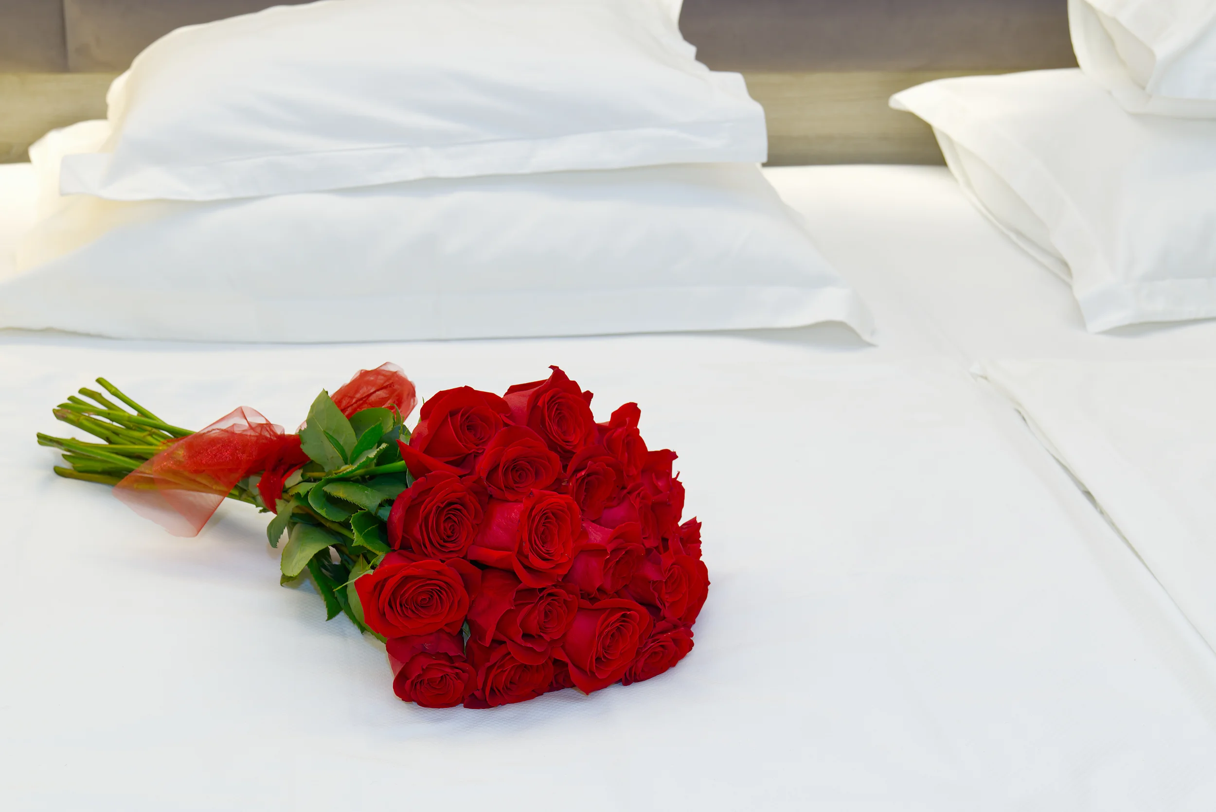 bouquet of roses on white bed