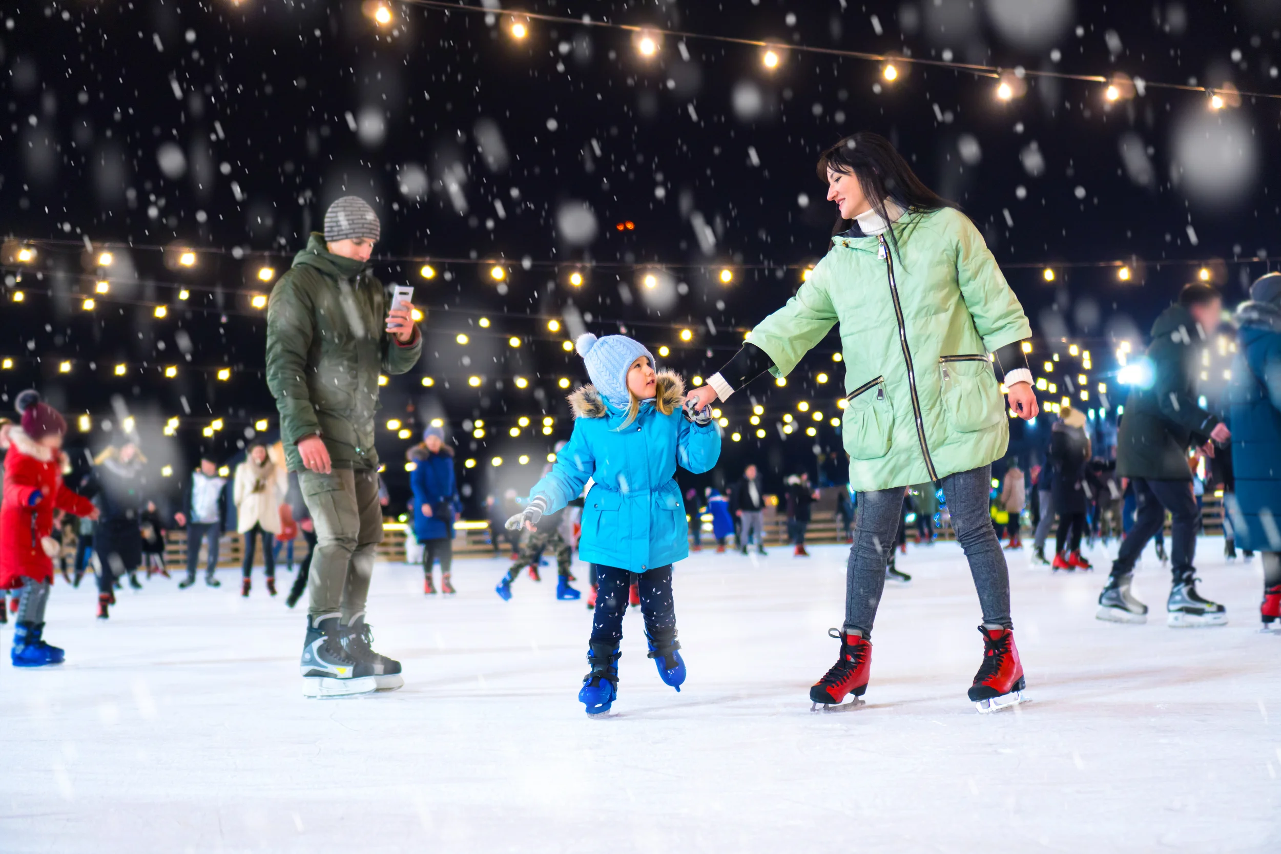 a family ice skating during winter in kentucky