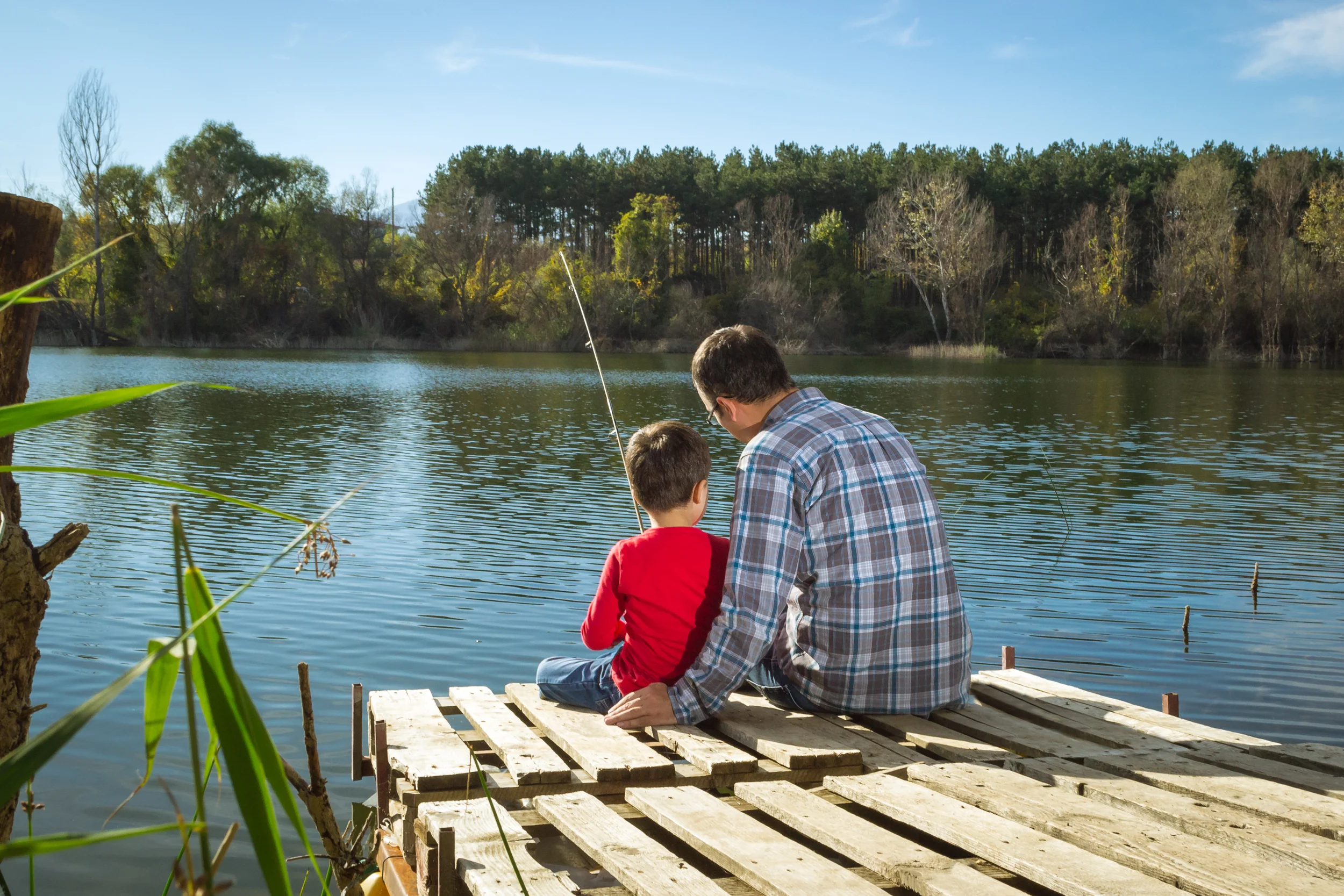 a father and son fishing on a dock in kentucky